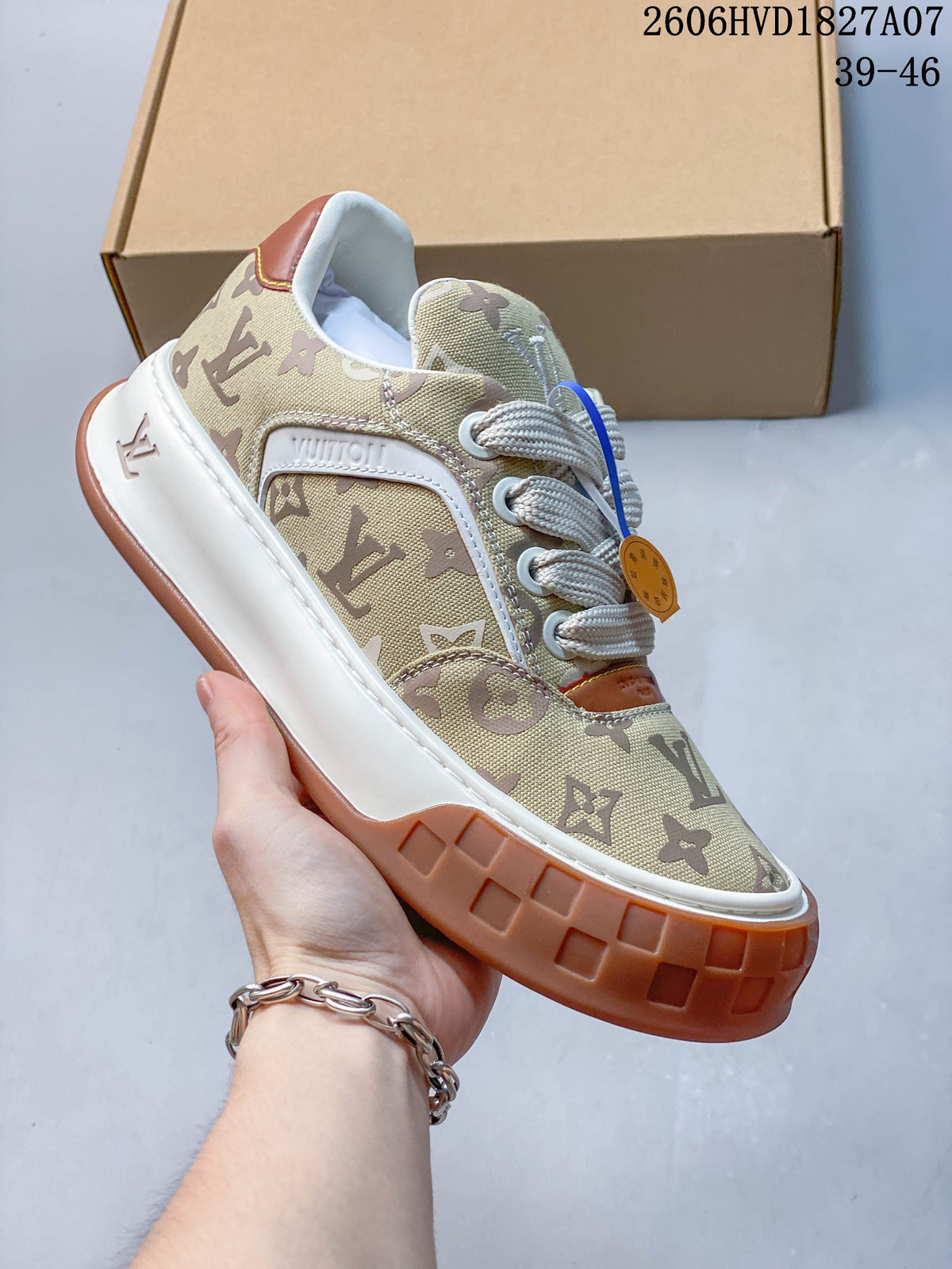 Angled side view highlighting the beige monogram upper, white midsole, and gum-brown outsole.