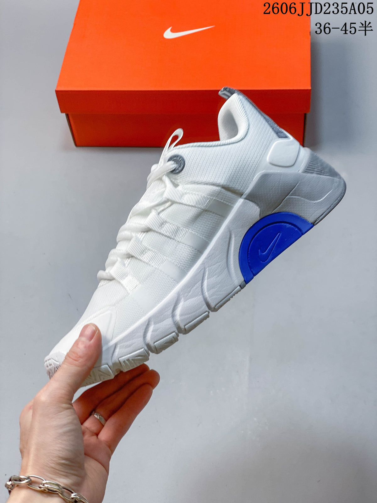 Side view of a white training shoe with blue midsole accents