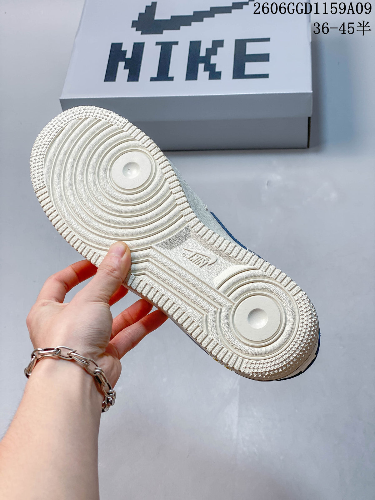 Textured outsole of an off-white and blue low-top sneaker