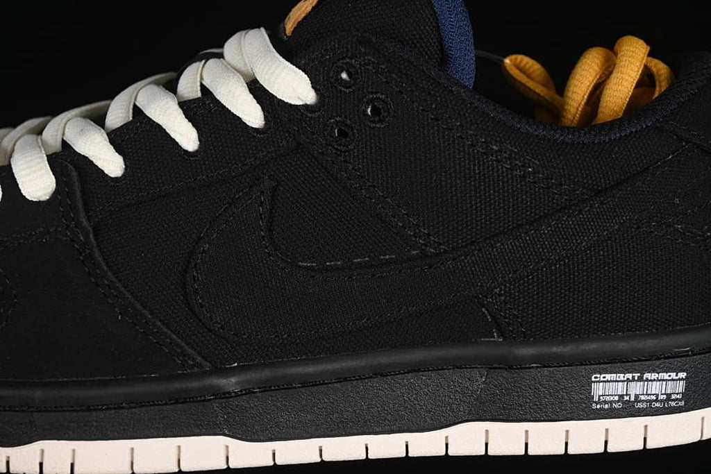 Close-up of the black side panel, swoosh, and white outsole detailing