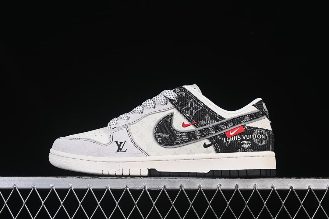 Side view of a white and black low-top SB Dunk-style sneaker with patterned overlays and red accents