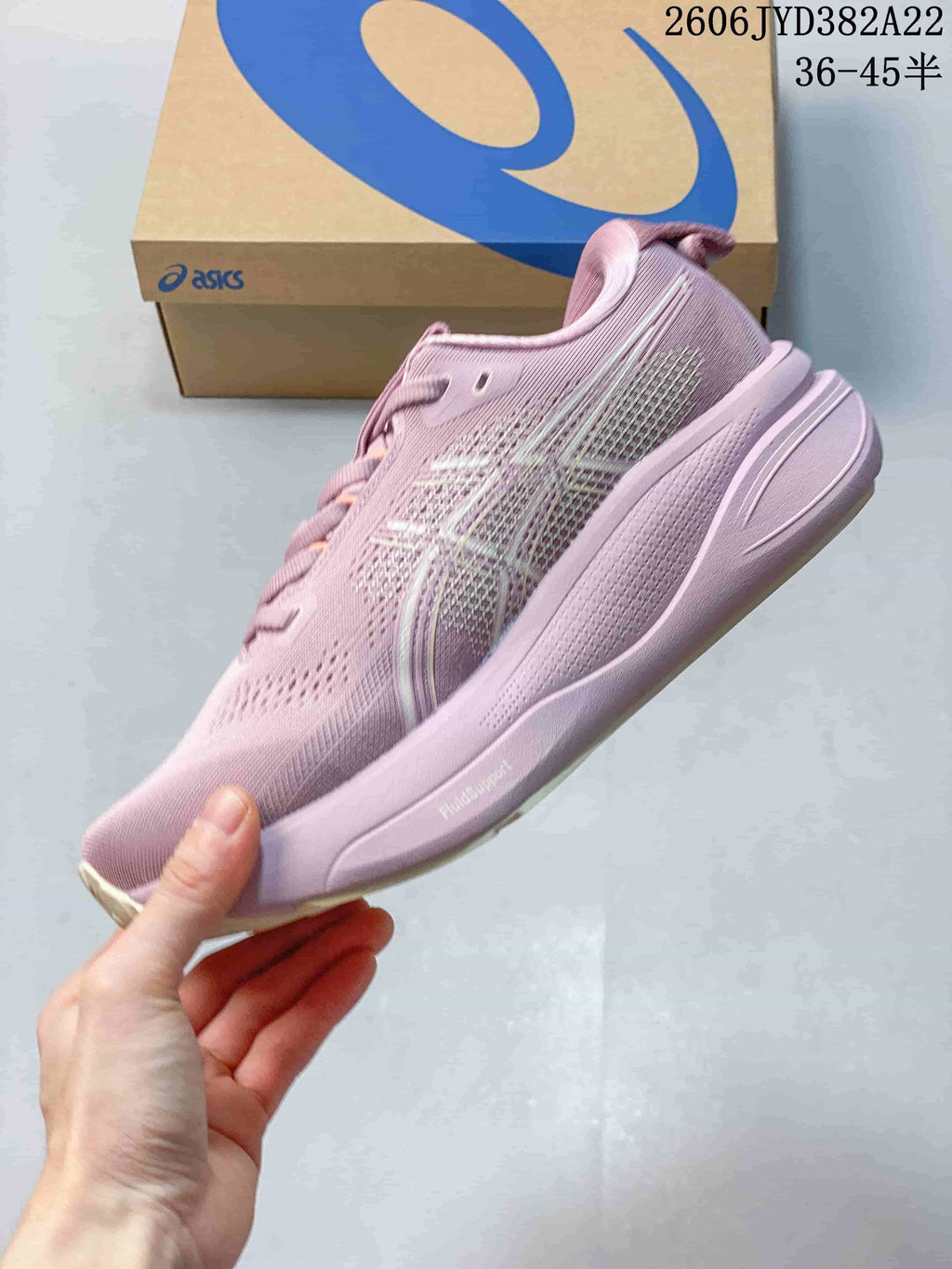 Side profile of the pink shoe showing the sole and FluidSupport marking