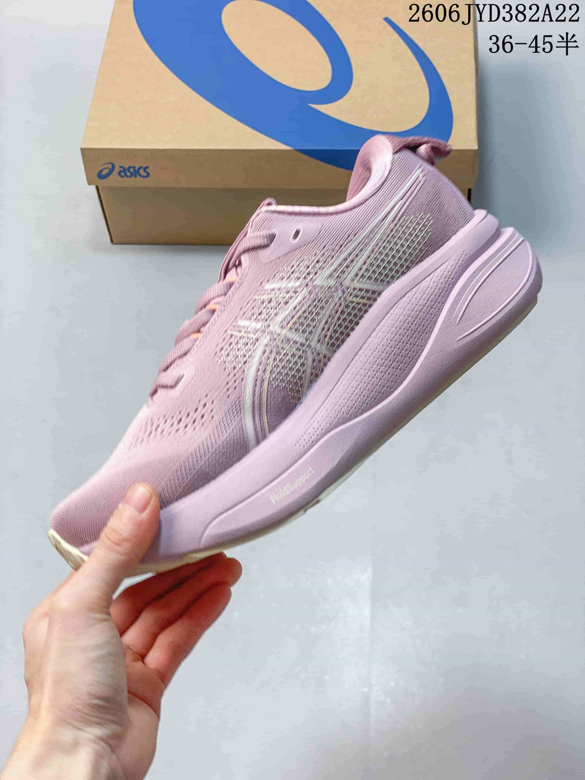 Side profile of the pink shoe showing the sole and FluidSupport marking