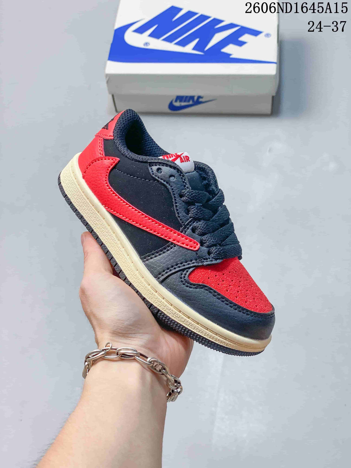 Side view of a navy and red kids’ low-top sneaker with a bright red side detail.
