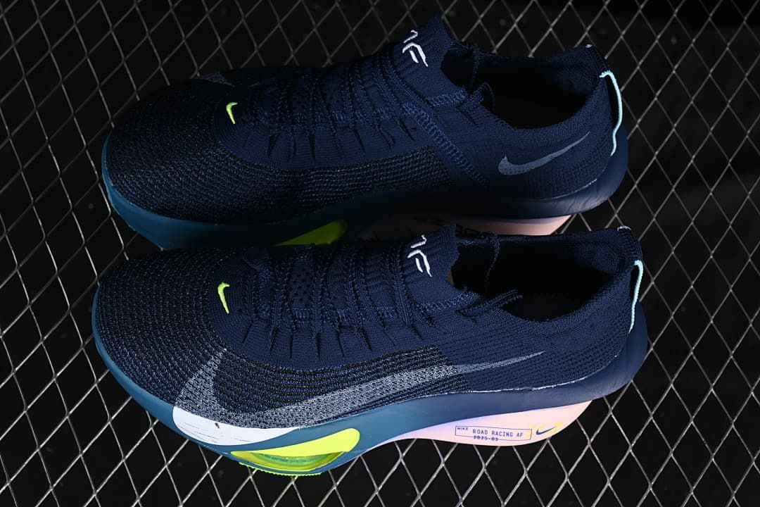 Pair of navy running shoes showing the side profile and multicolor soles.