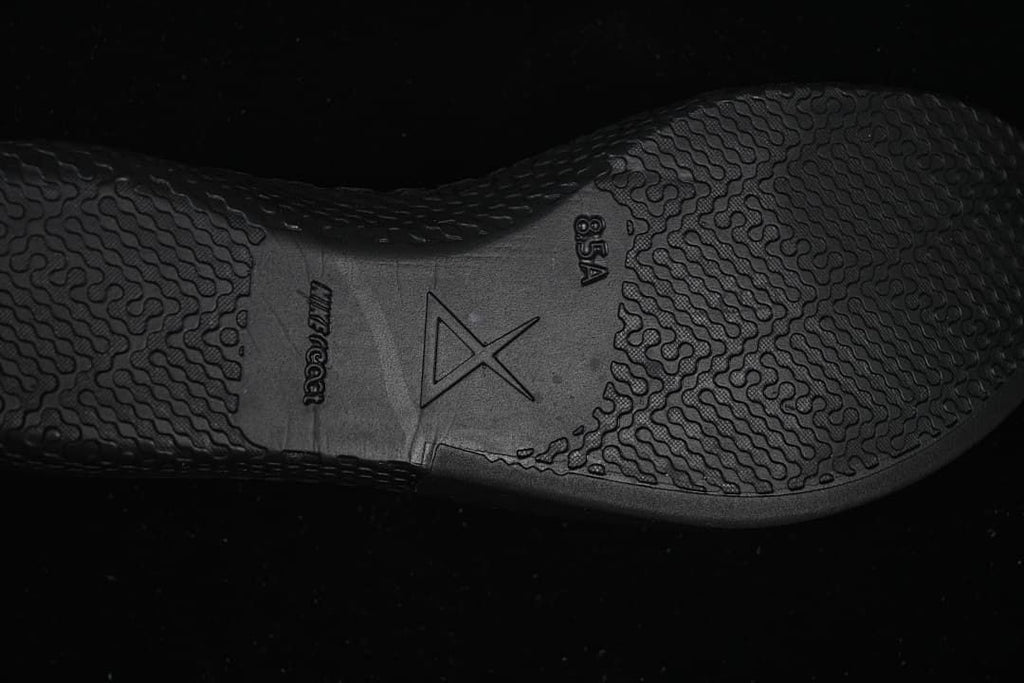 Close-up of textured black outsole with Kobe-style emblem