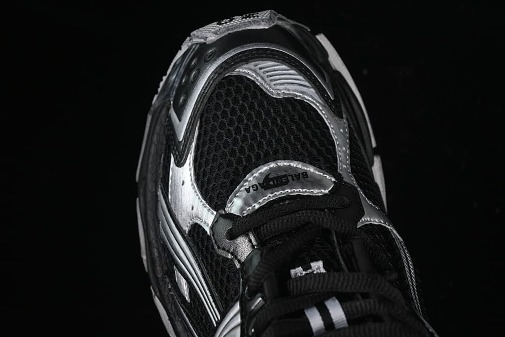 Angled close-up of the mesh toe and silver overlay details.