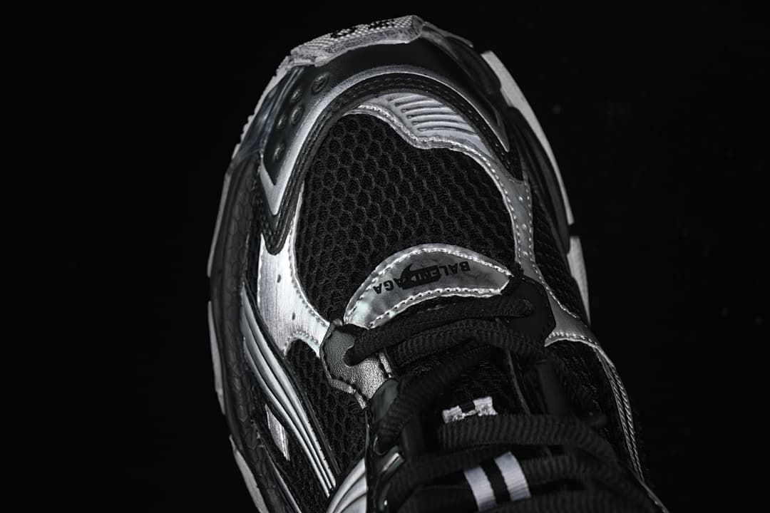 Angled close-up of the mesh toe and silver overlay details.