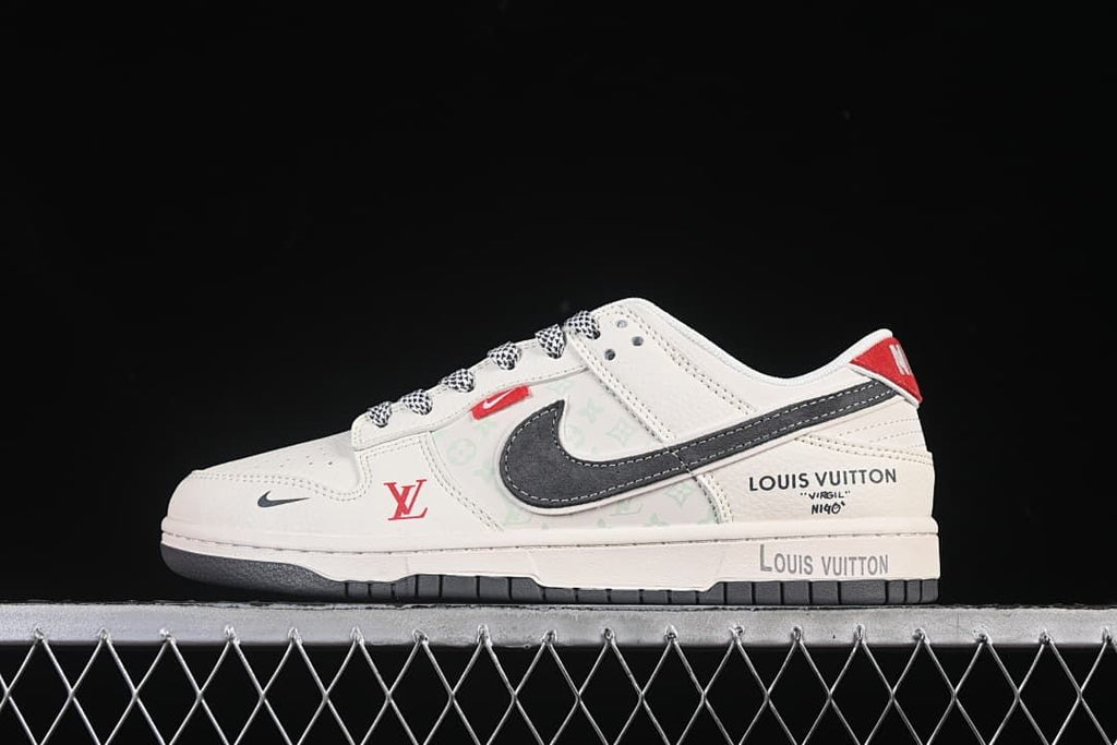 Side view of a cream Nike SB Dunk Low with a dark gray Swoosh, red accents, and Louis Vuitton and NIGO branding details.
