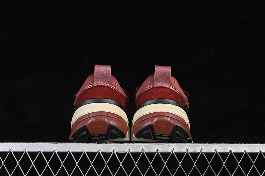 Rear view of both shoes showing heel pull tabs and outsoles