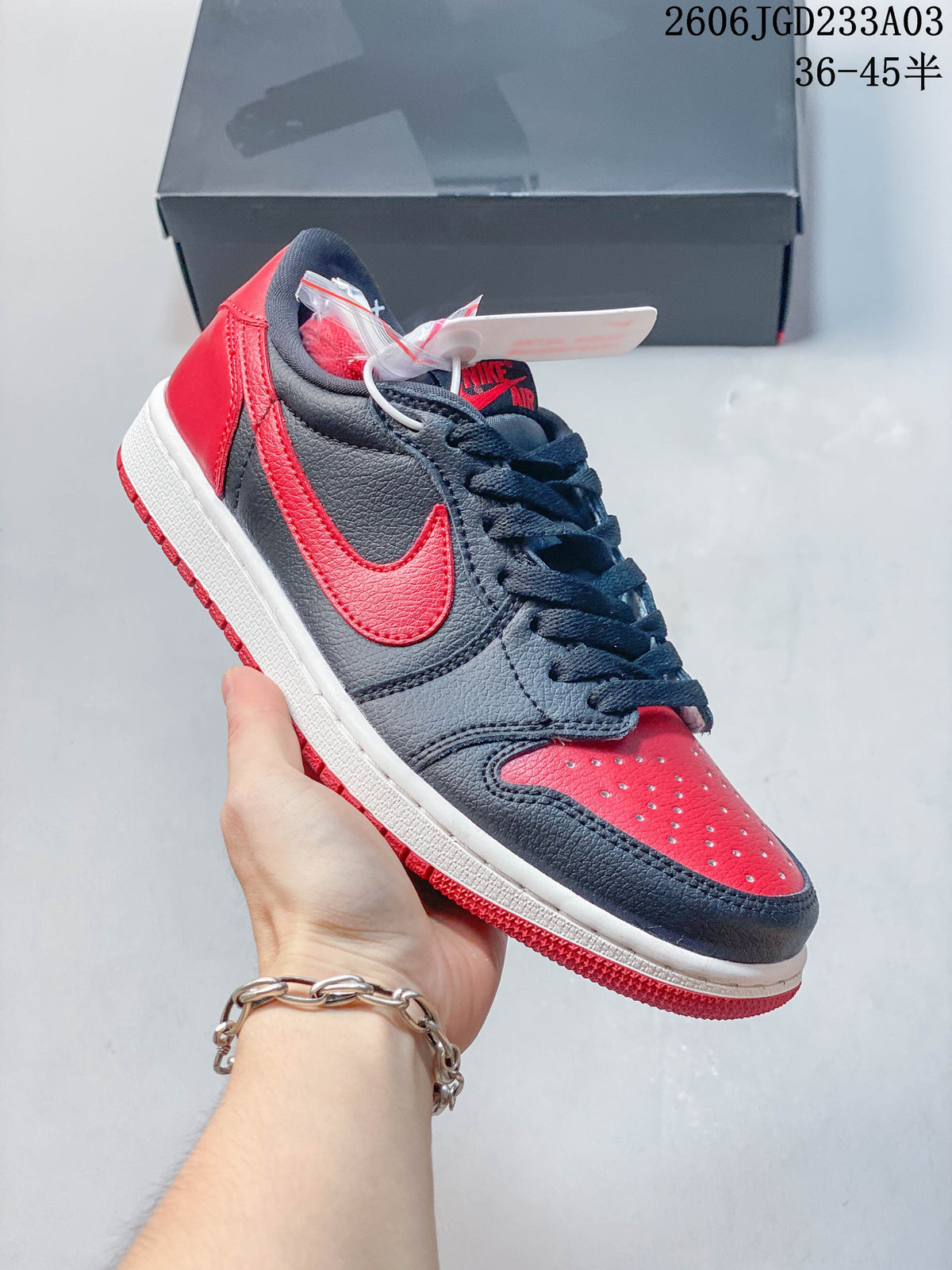 Angled side view of a black and red low-top sneaker
