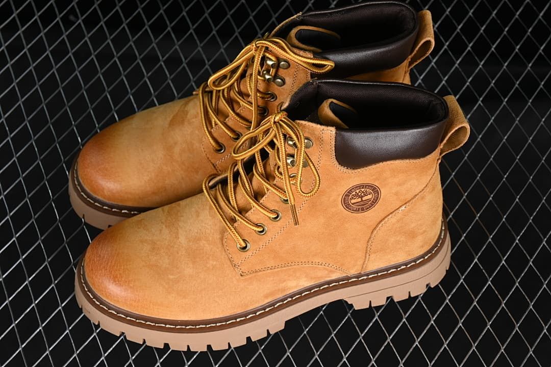 Pair of yellow-brown lace-up boots shown at an angle