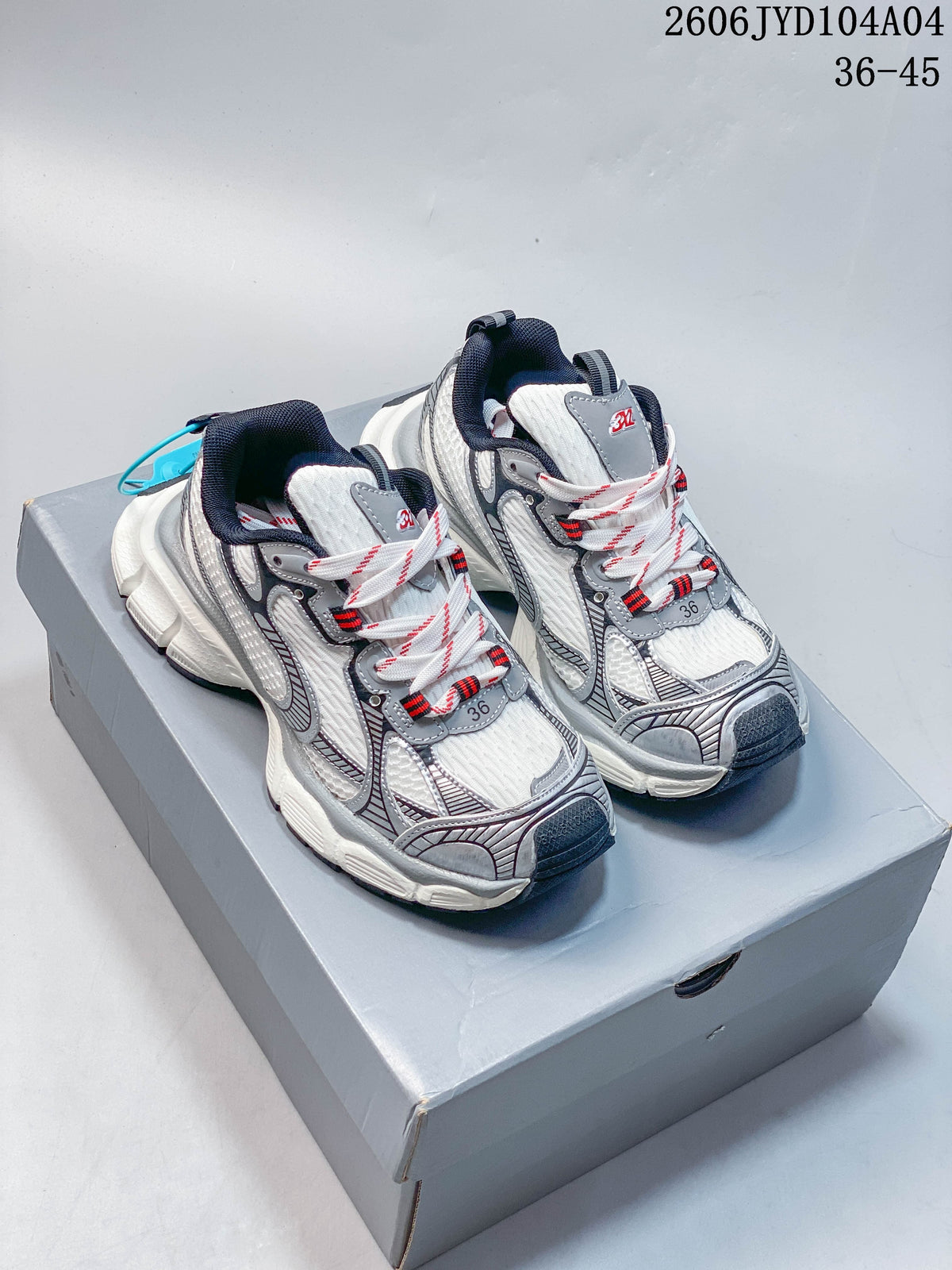 White and gray chunky low-top sneakers shown from above on a box