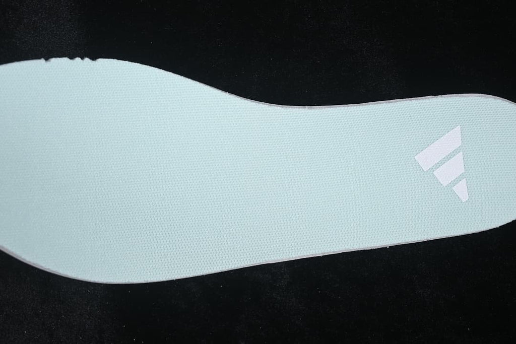 Pale mint sneaker insole with a small logo