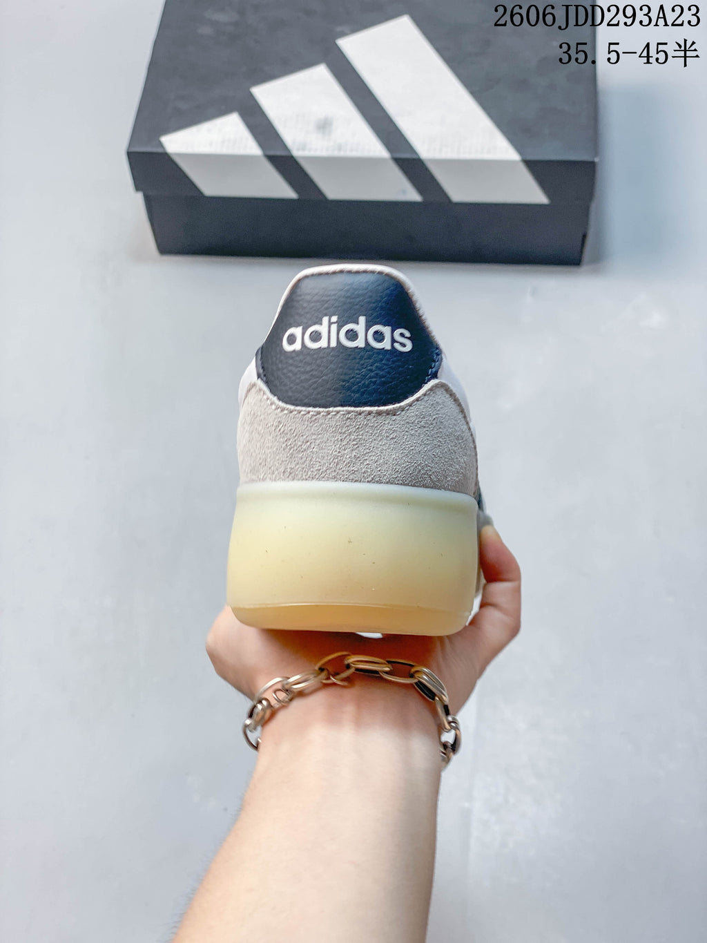 Rear view of the sneaker with gray heel panels and a pale gum-colored sole