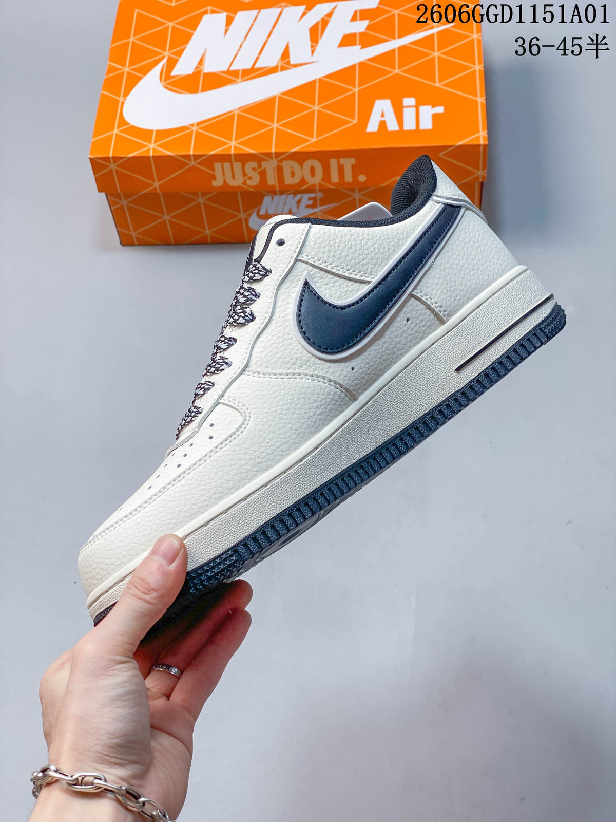 Side view of the white low-top sneaker with dark Swoosh and patterned laces