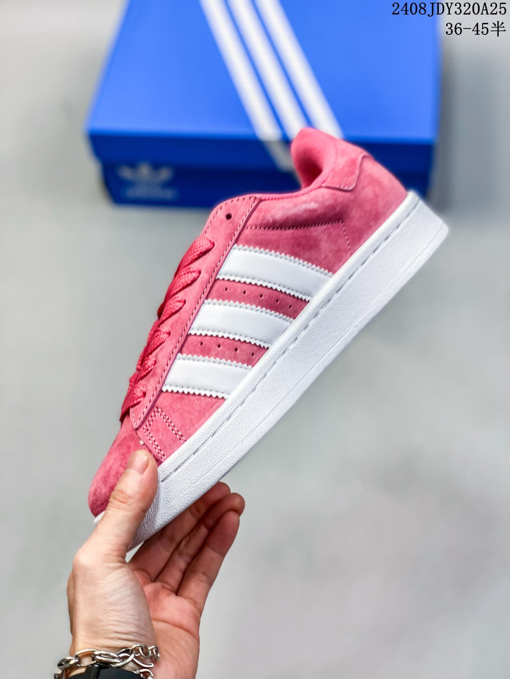 Side view of a pink low-top sneaker with white stripes and a white sole.