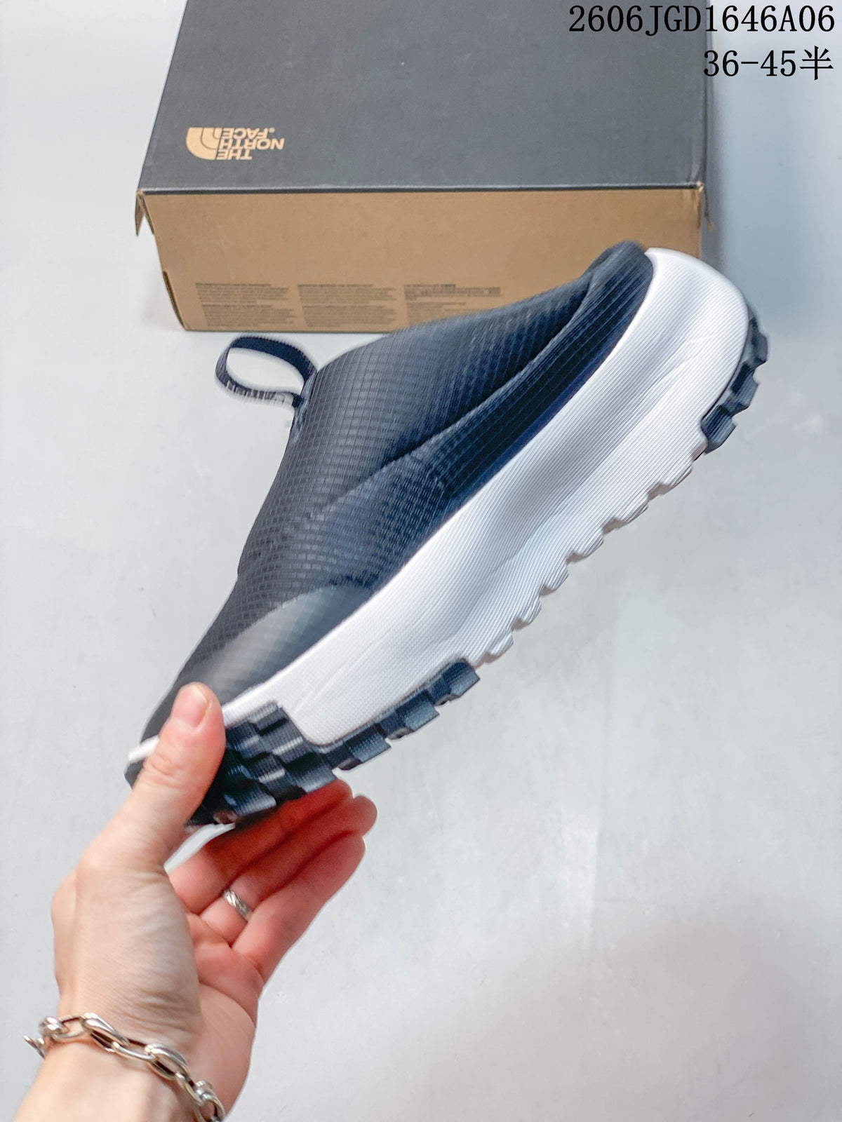 Side profile of the navy slip-on mule with a white midsole