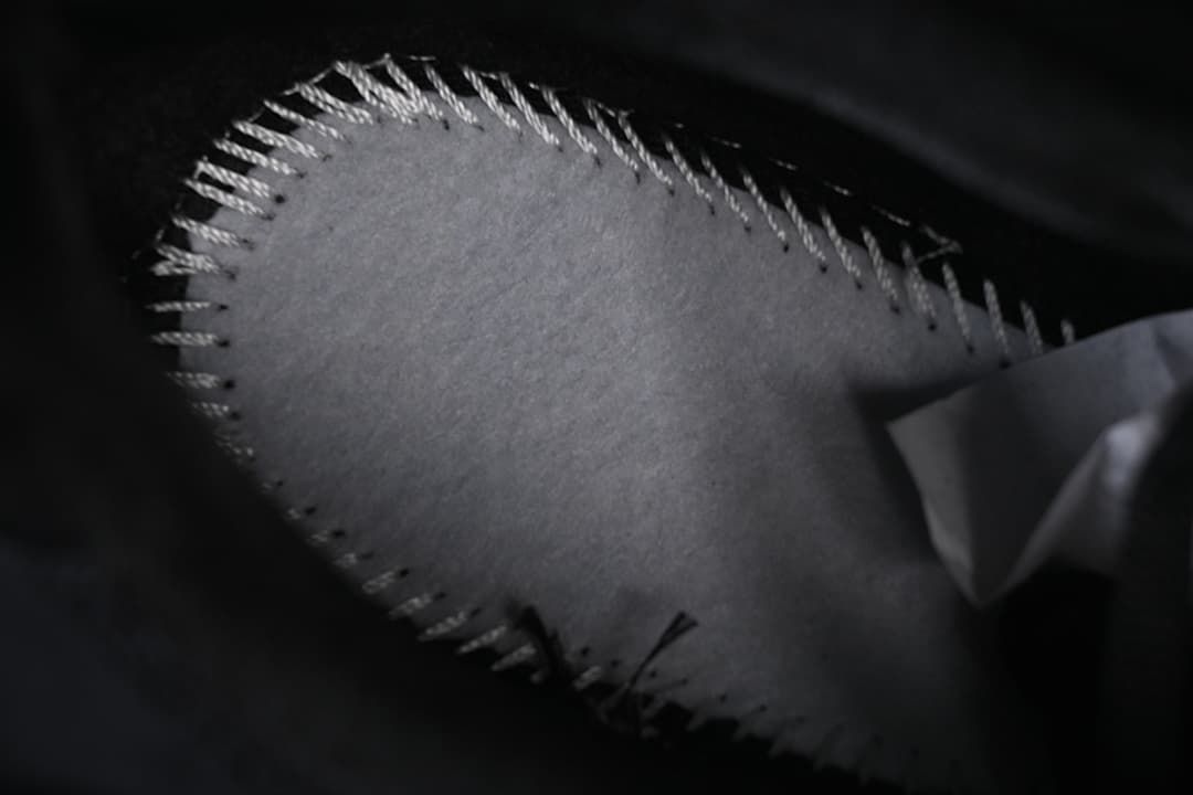 Close-up of stitching along a shoe panel.