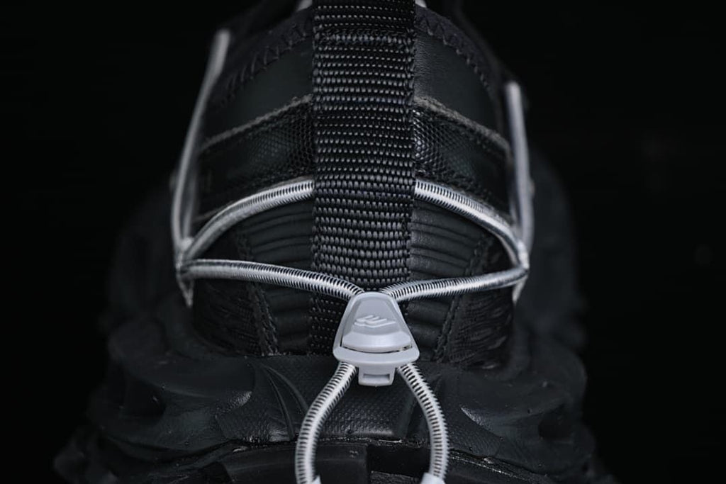 Rear view showing the heel pull loop, cord lacing and outsole.