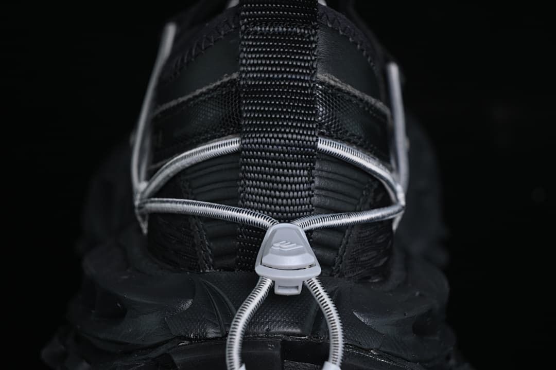 Rear view showing the heel pull loop, cord lacing and outsole.