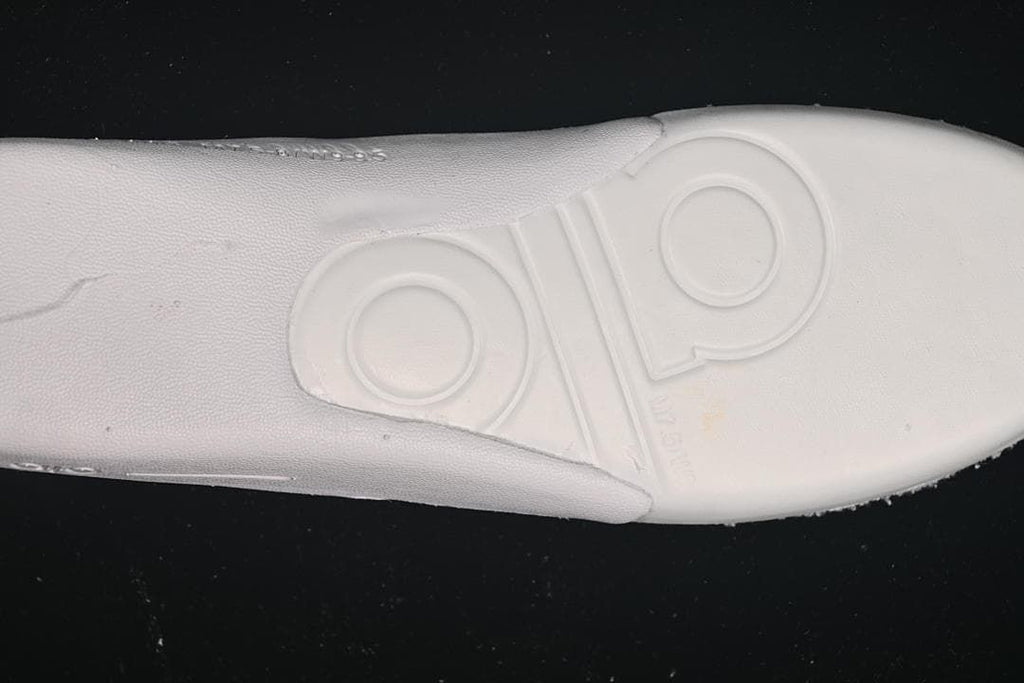Close-up of the sneaker's white insole underside with embossed branding