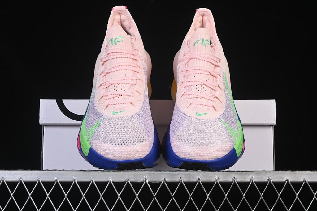Front view of the pair showing pink uppers, lavender-toned panels, and blue toe soles