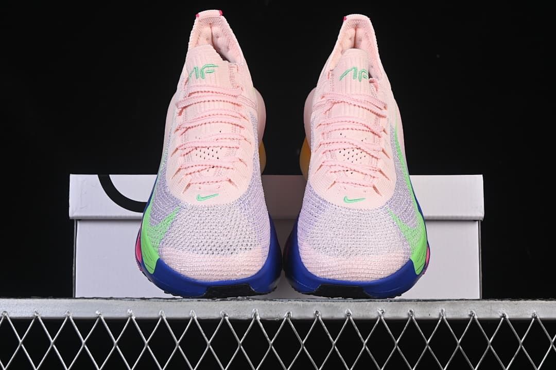 Front view of the pair showing pink uppers, lavender-toned panels, and blue toe soles