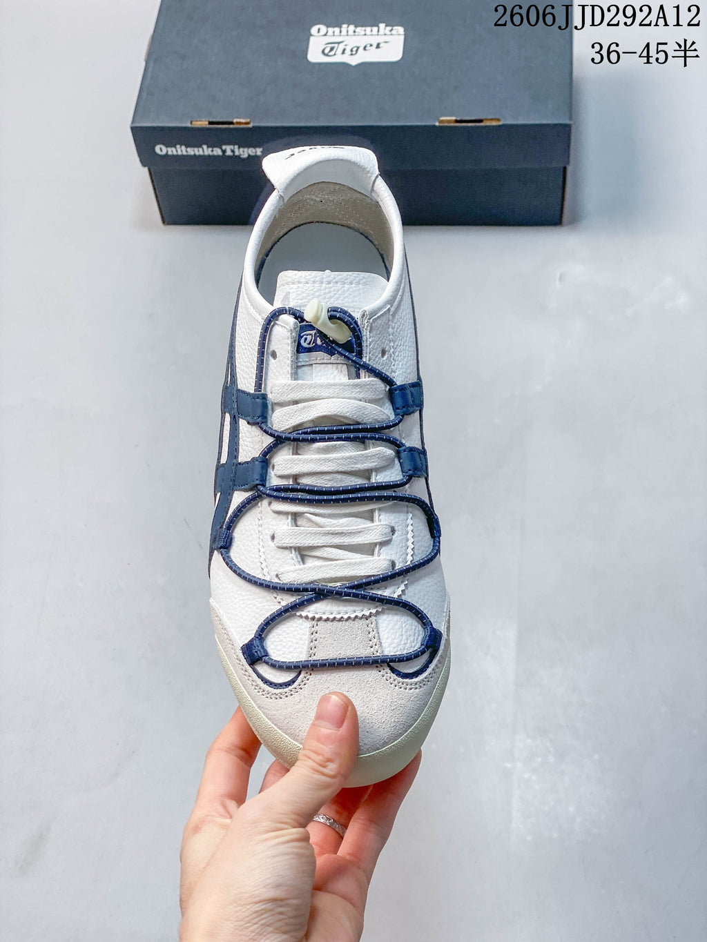 Top-down view showing the white laces and navy decorative lace detailing.