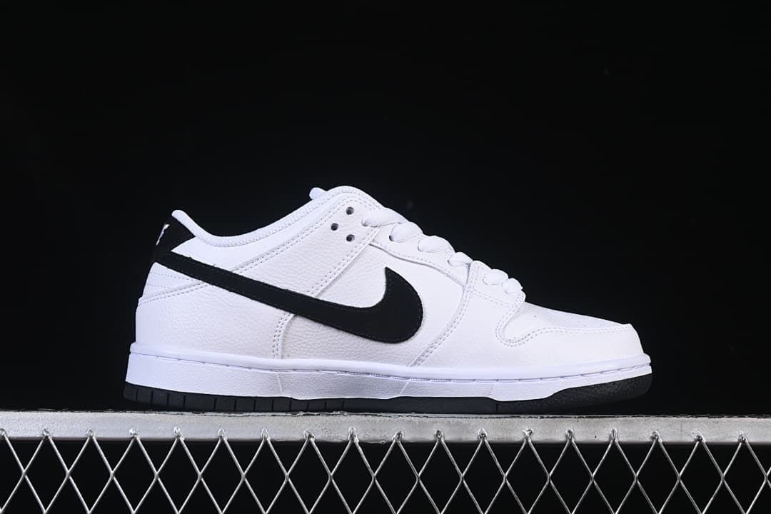 Side profile of the white sneaker with a black Swoosh