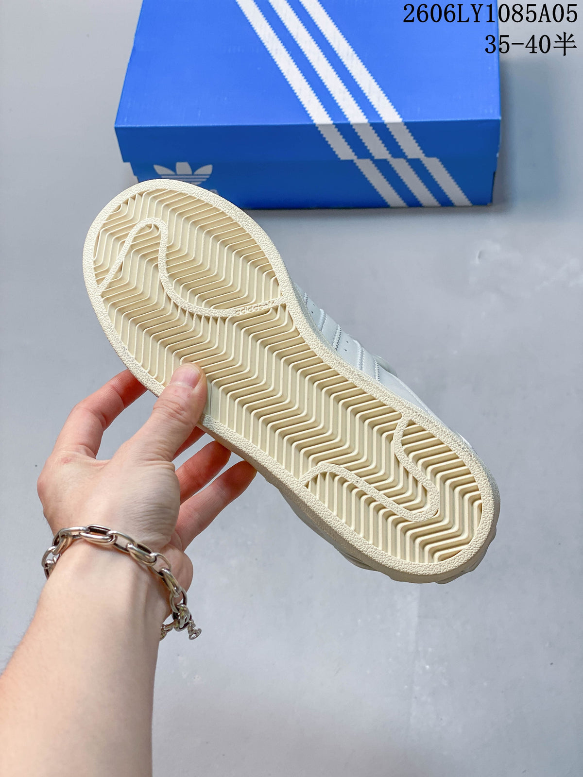 Underside of an off-white sneaker showing a patterned outsole