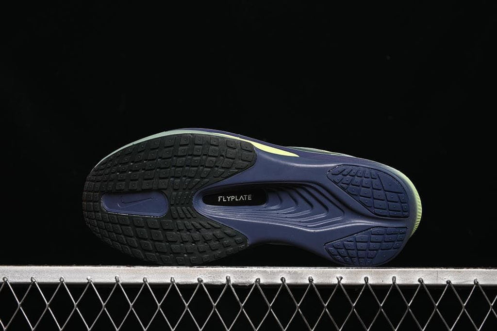 Underside view showing segmented outsole tread and Flyplate marking