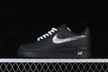 Side view of a black low-top sneaker with white laces and an illustrated Swoosh graphic