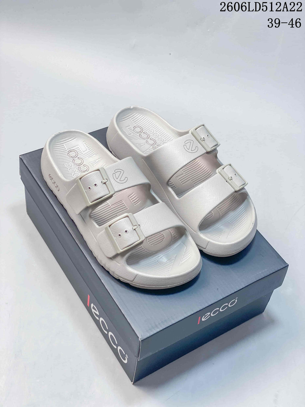 Pair of light gray ECCO two-strap sandals with buckles, shown on a shoe box