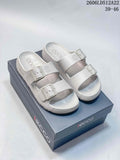 Pair of light gray ECCO two-strap sandals with buckles, shown on a shoe box