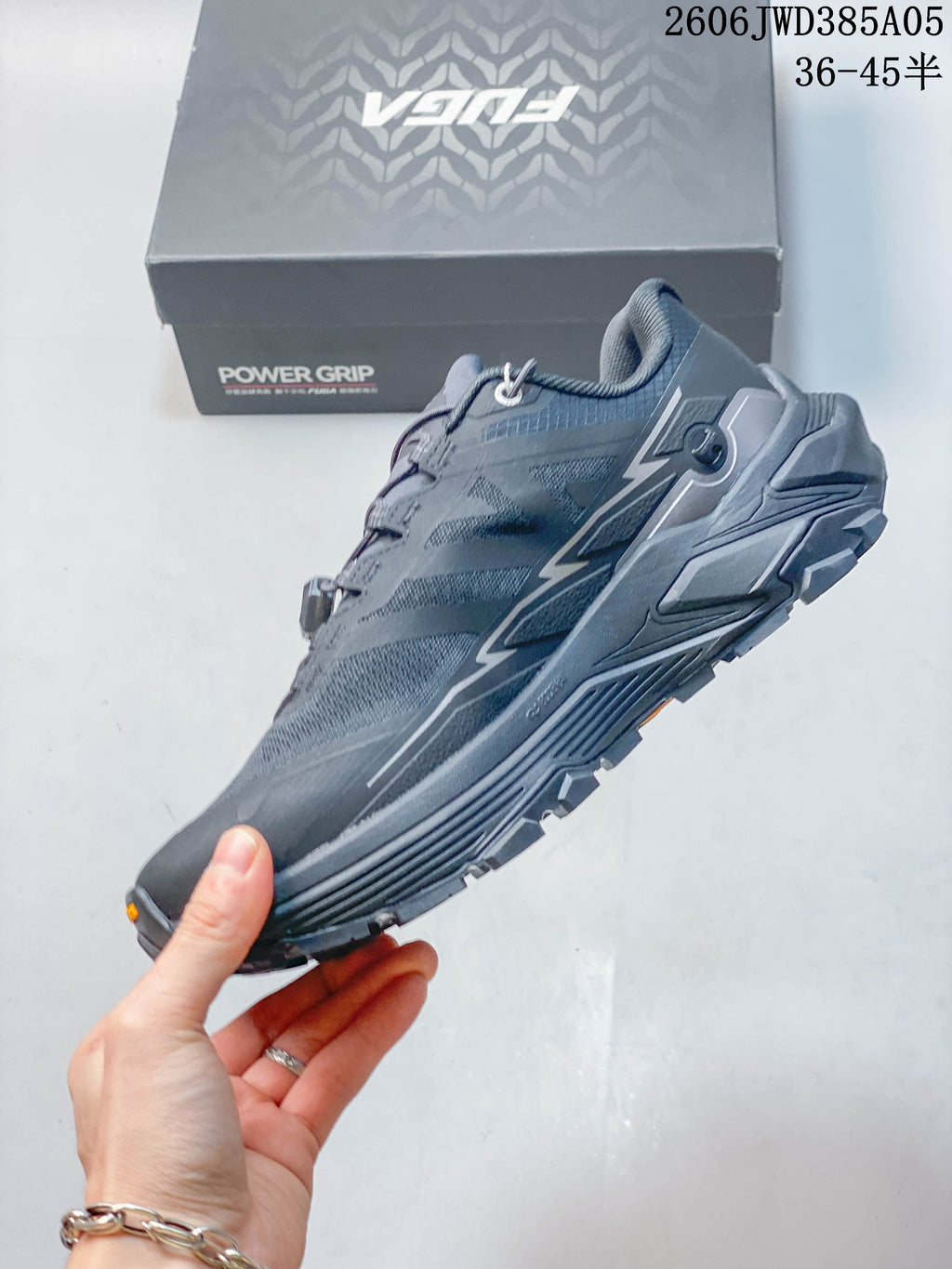 Side view showing the gray upper, dial lace system, and rugged sole
