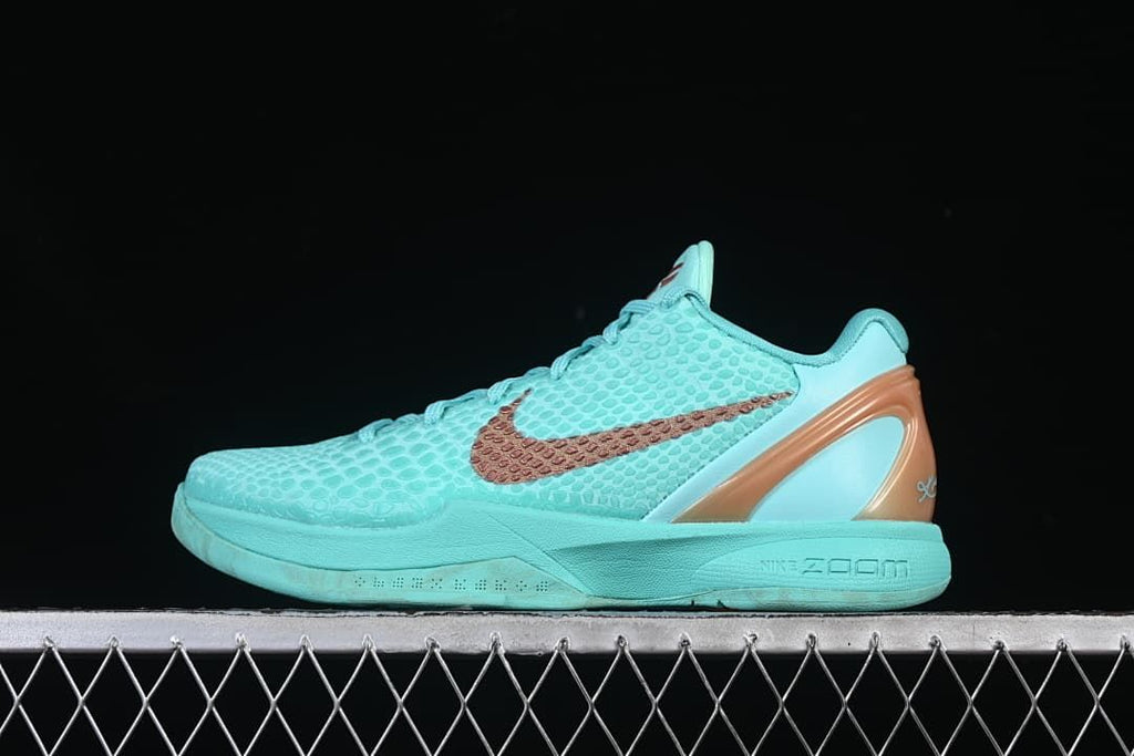 Side view of turquoise Nike Kobe VI Protro basketball shoe with copper-toned accents.