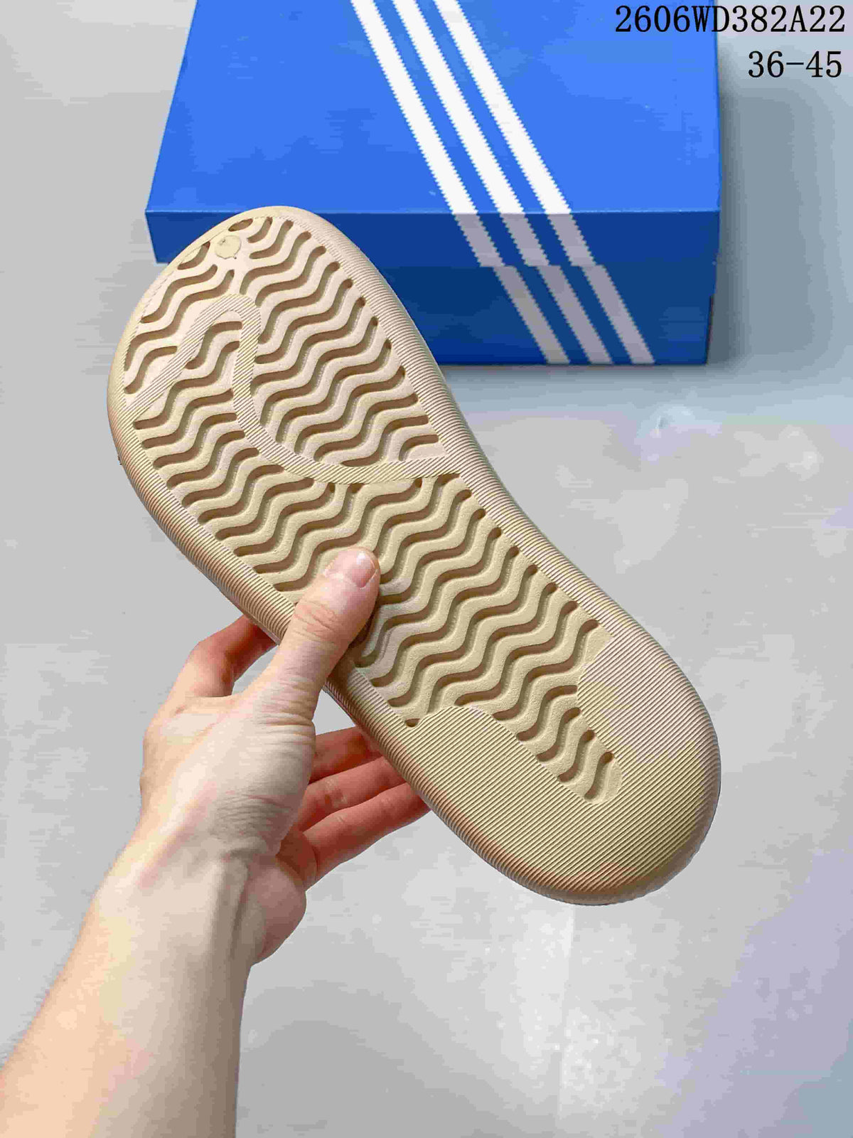 Close-up of the wavy textured outsole on a beige clog