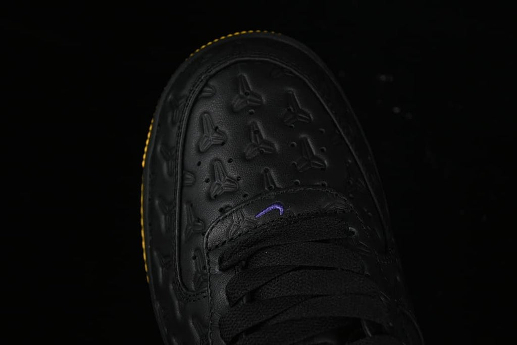 Top view of the embossed black toe and black laces.