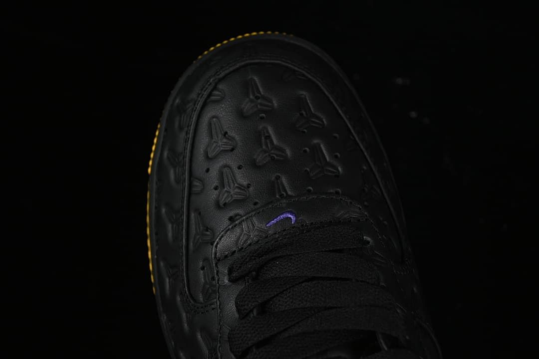 Top view of the embossed black toe and black laces.