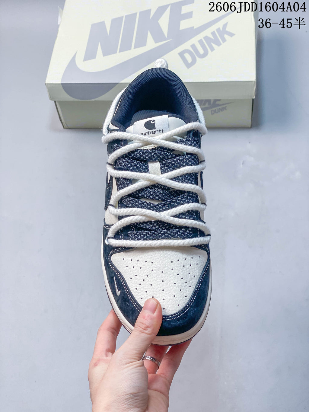 Top view showing the patterned tongue, thick white laces, and perforated toe panel.