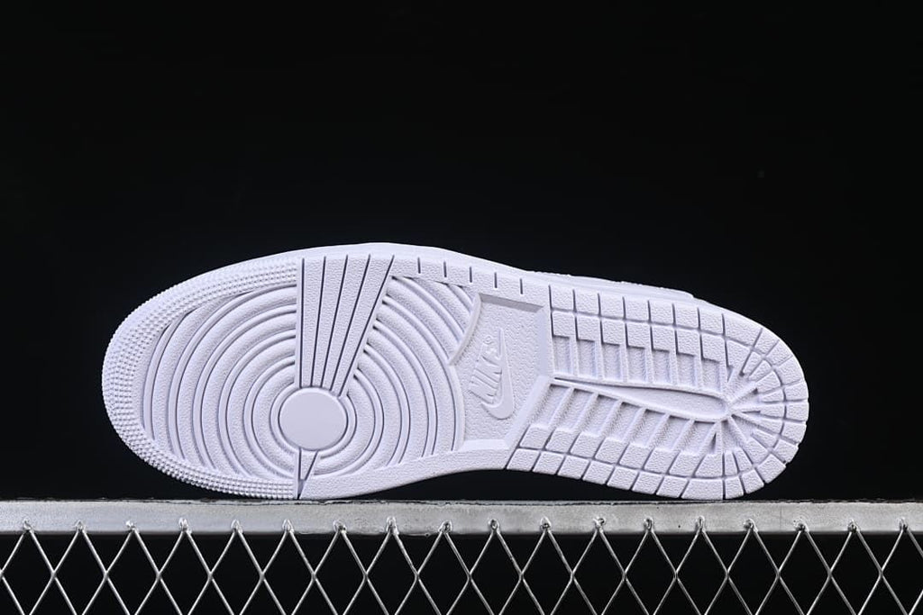 Underside view of the white outsole with circular tread pattern