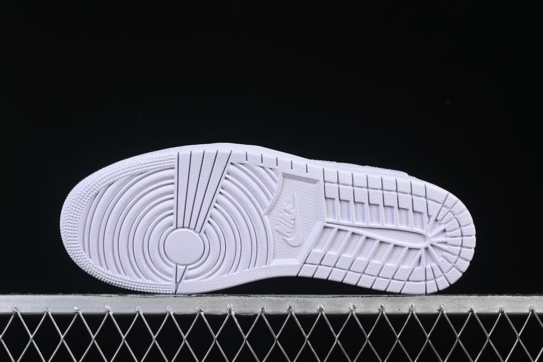 Underside view of the white outsole with circular tread pattern