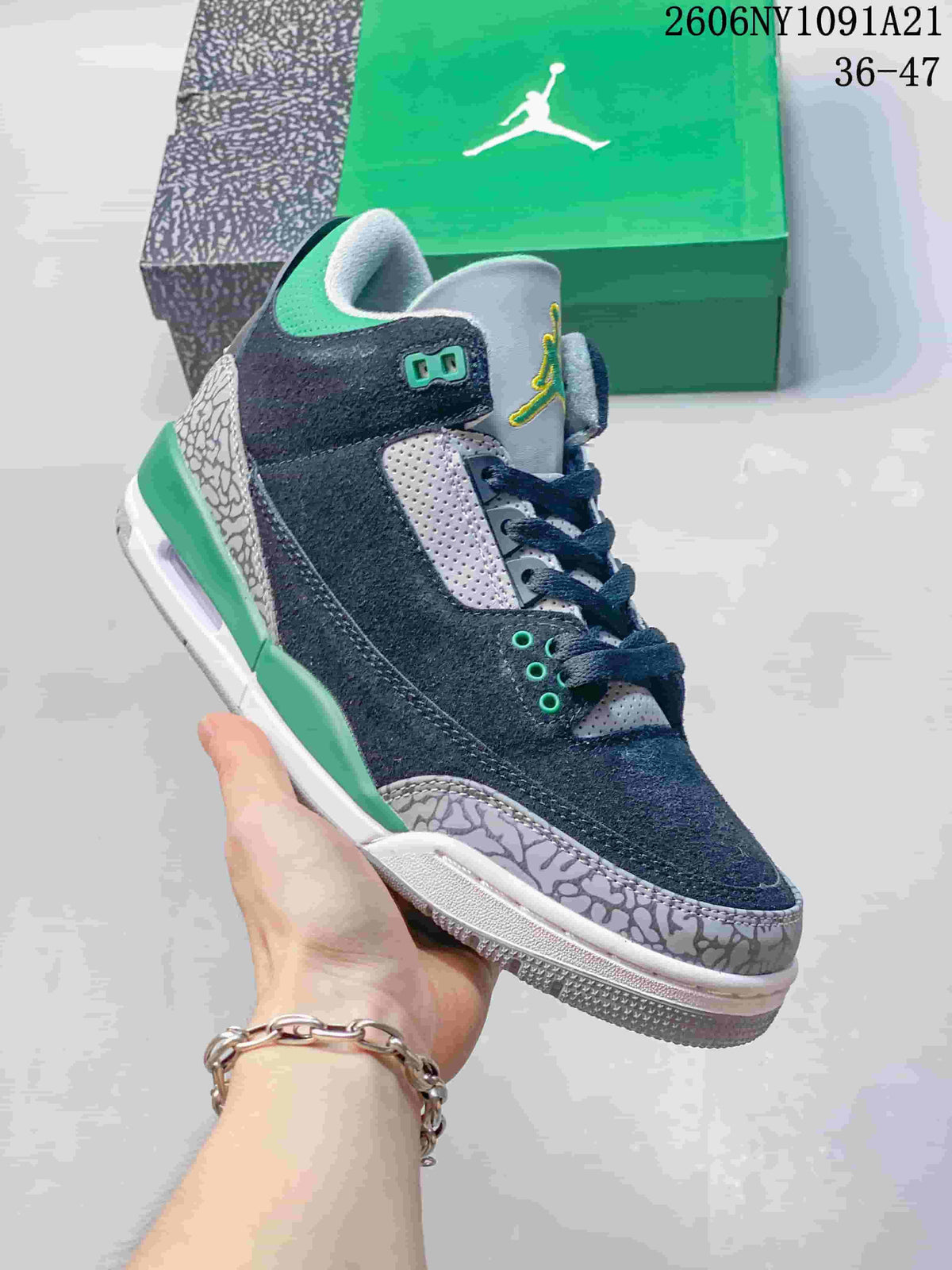 Side view of the sneaker showing its navy upper, grey panels, green details, and patterned overlays
