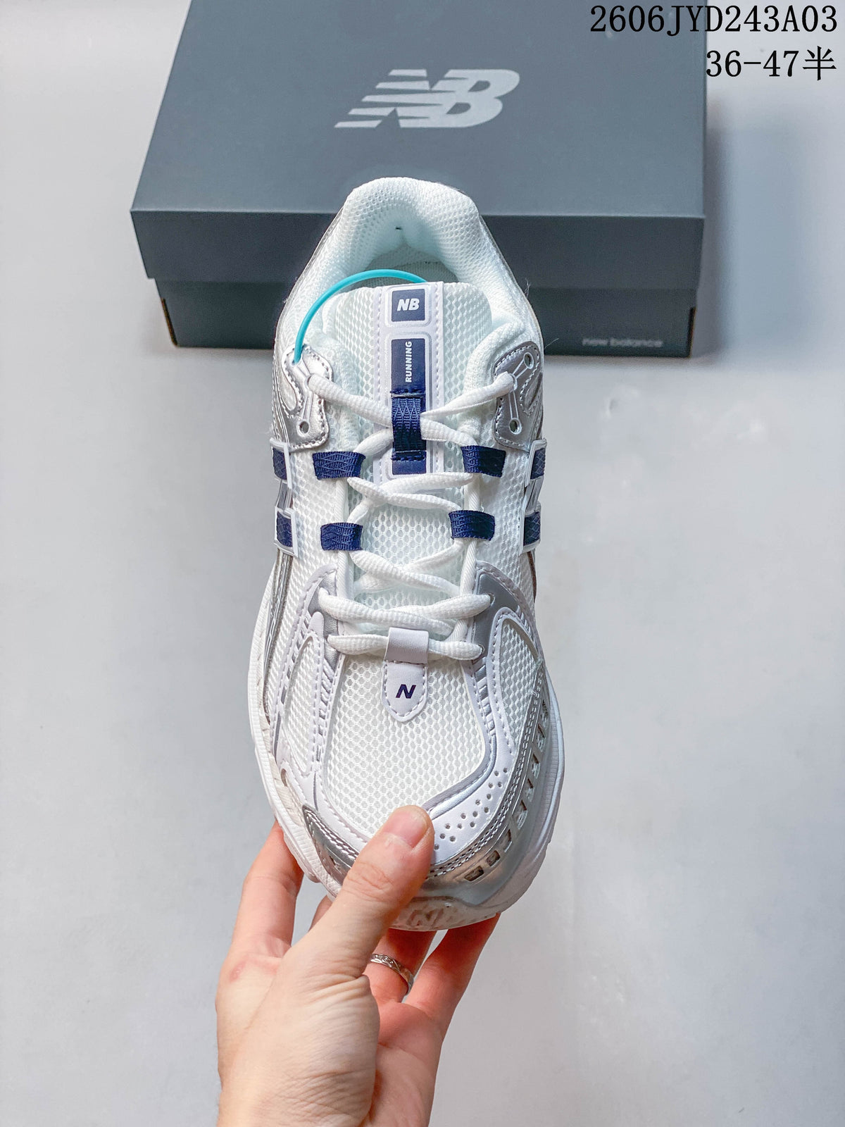 Top view of a white sneaker showing the laces and mesh-look upper