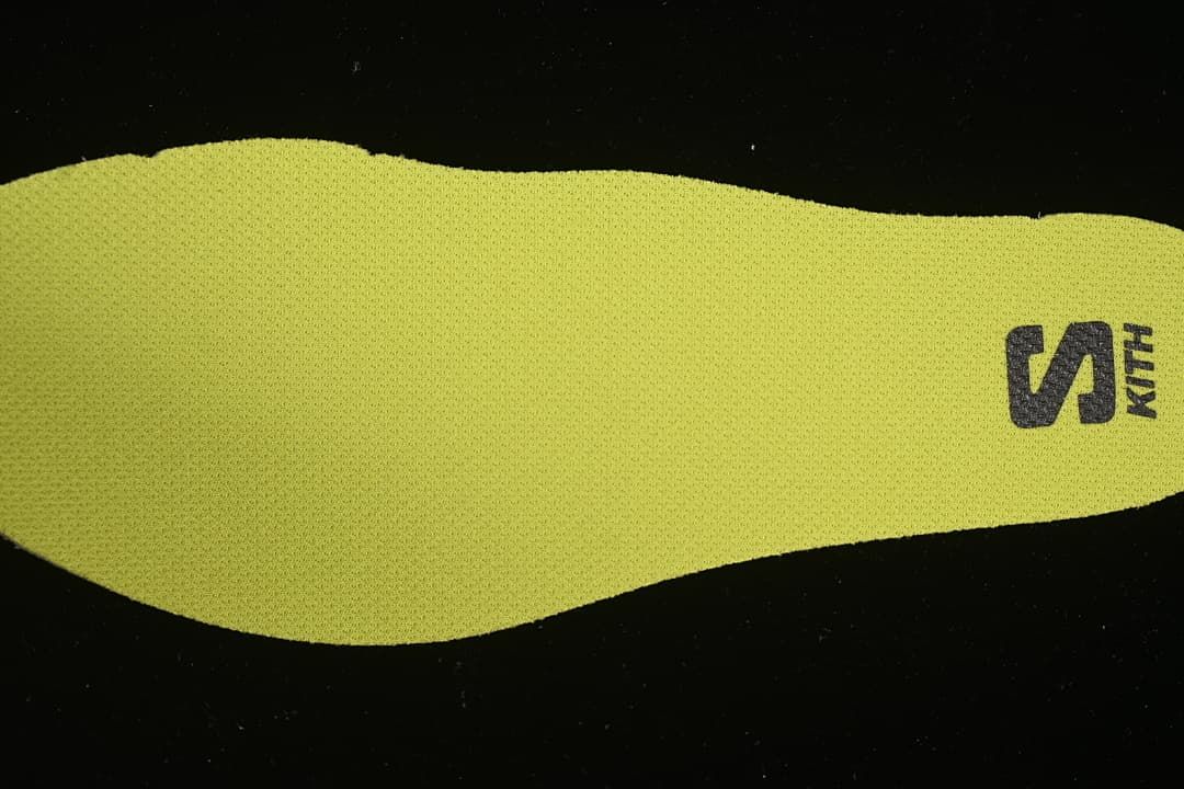 Bright lime shoe insole with Salomon branding
