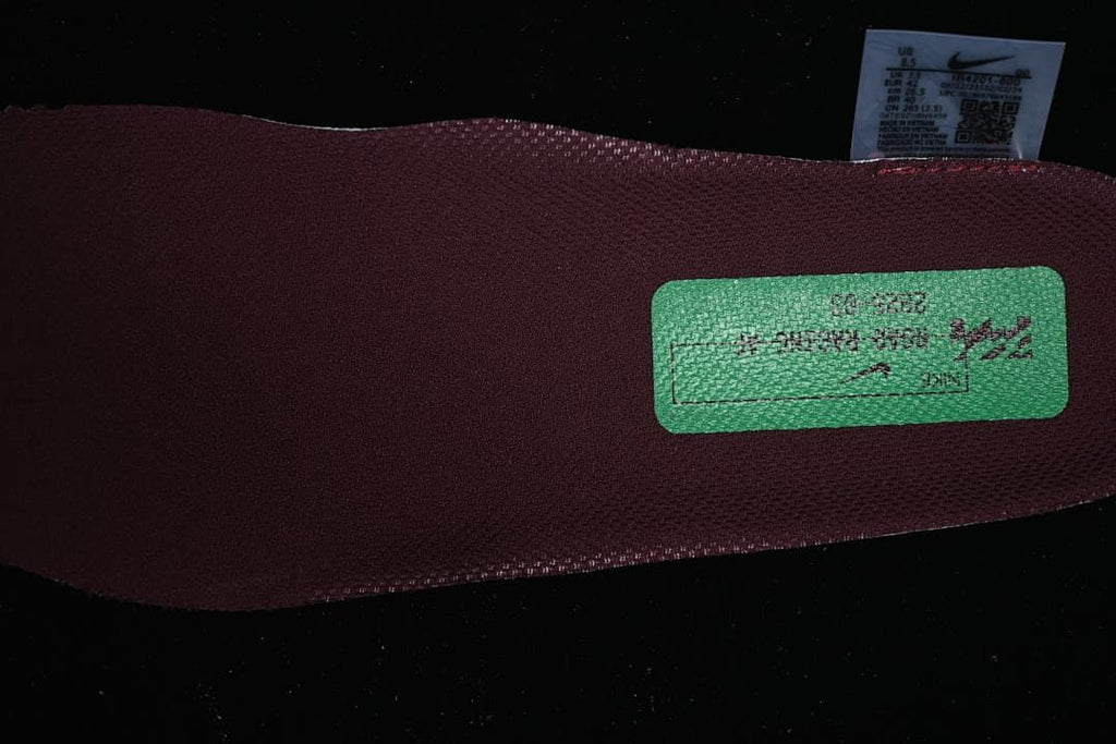 Close-up of the burgundy shoe interior and a small label