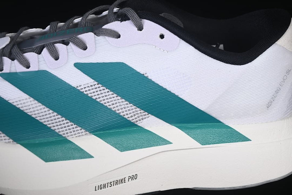 Close side view highlighting teal stripes, the mesh-like upper, and Lightstrike Pro marking.