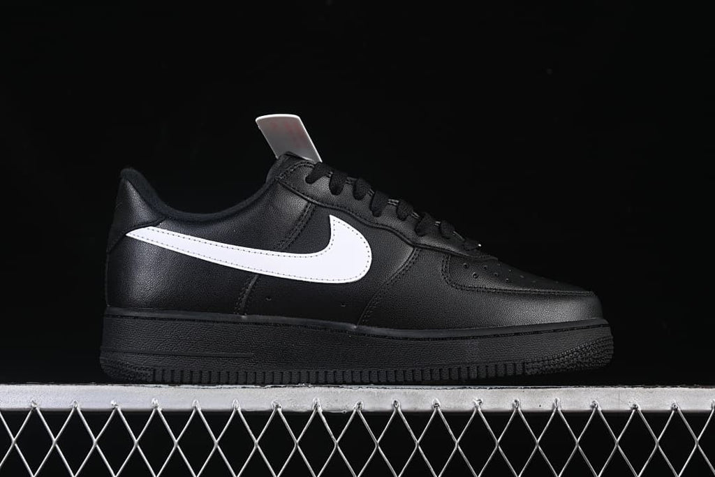 Side profile showing the black upper, white Swoosh, and black sole