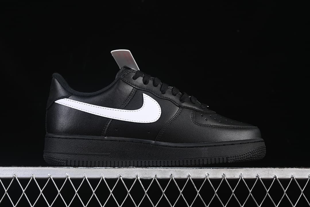 Side profile showing the black upper, white Swoosh, and black sole